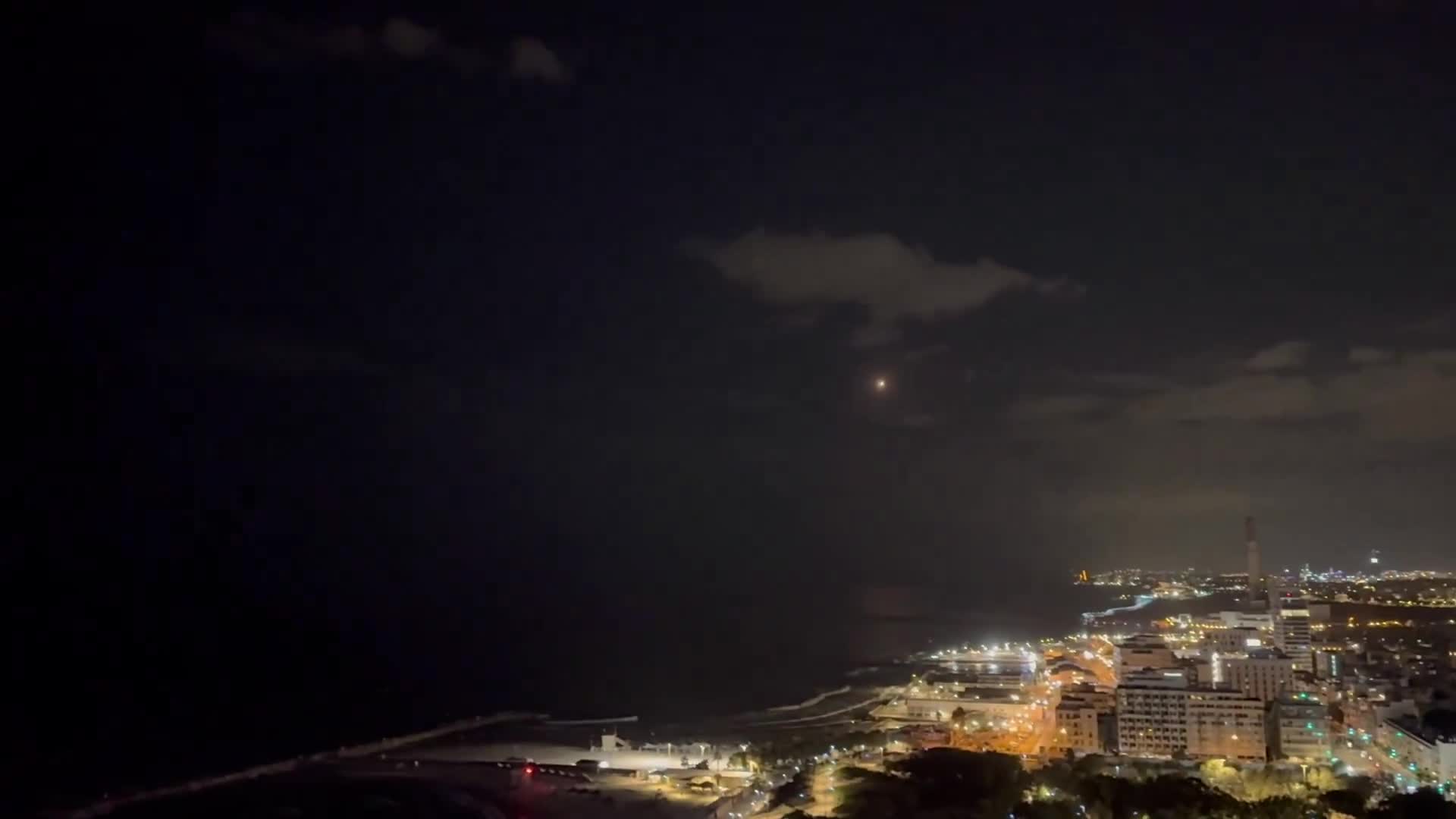 Multiple missile interceptors fly over Tel Aviv - followed by explosions over the Mediterranean Sea